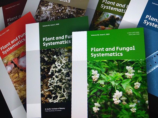 Several issues of the journal arranged side by side with covers in a variety of vibrant colors